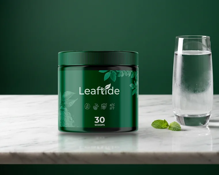 Leaftide supplement powder tub beside a glass of water on a marble slab